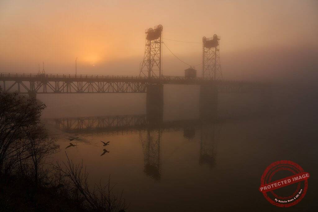 Old lift bridge in Selkirk Manitoba on a misty sunrise morning.