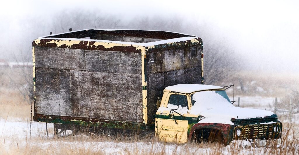 Old grain truck with a snow-covered cab
