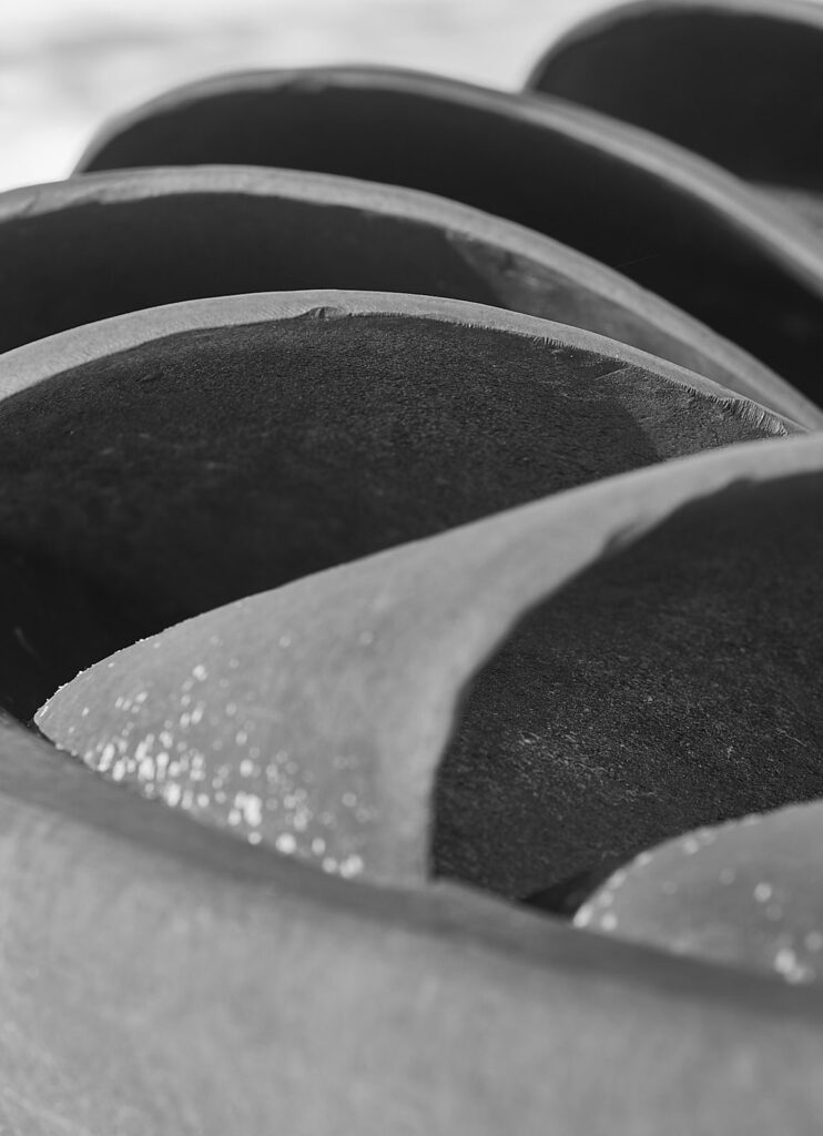 Curved metal shapes catching soft light