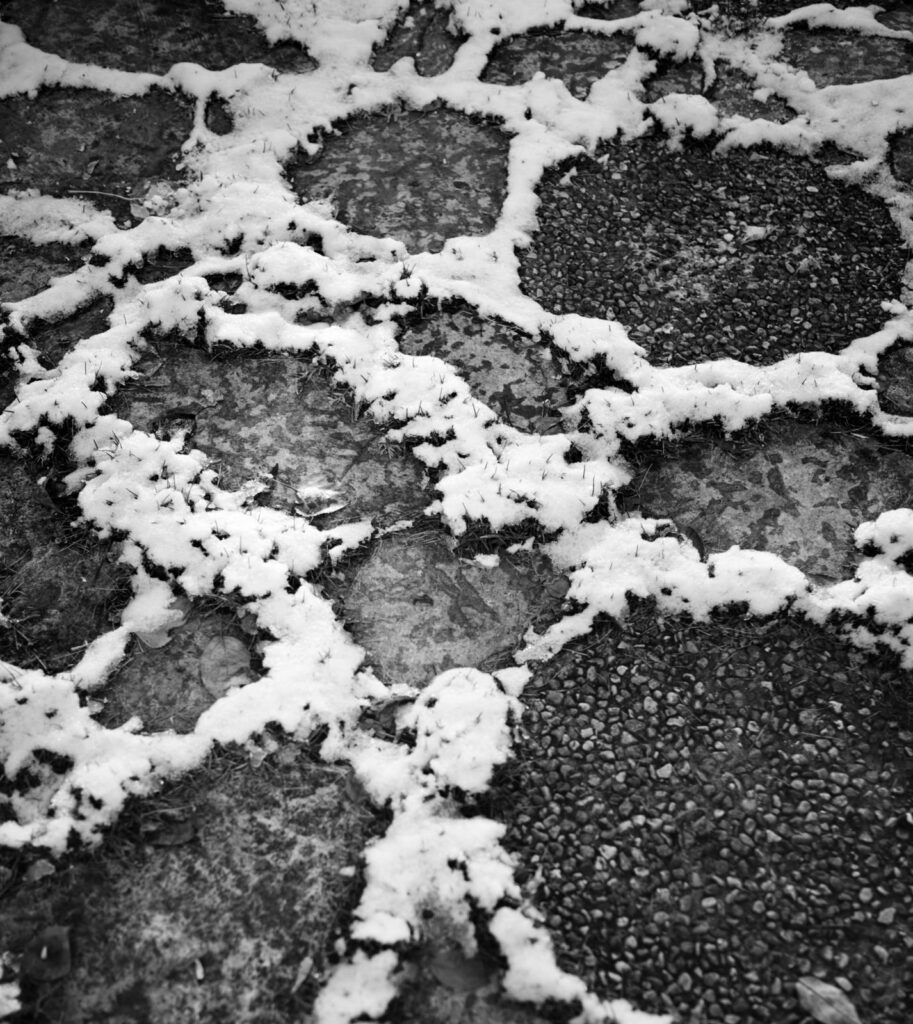 A snow-rimmed pattern on frozen ground