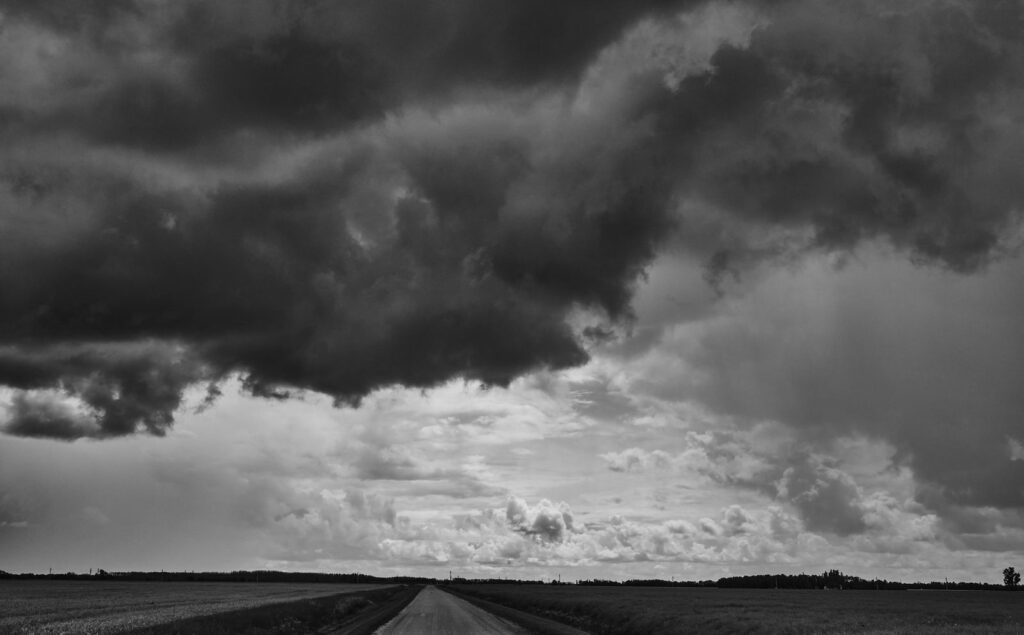 Towering storm clouds over an empty road