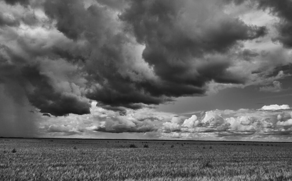 Heavy clouds above a flat prairie field