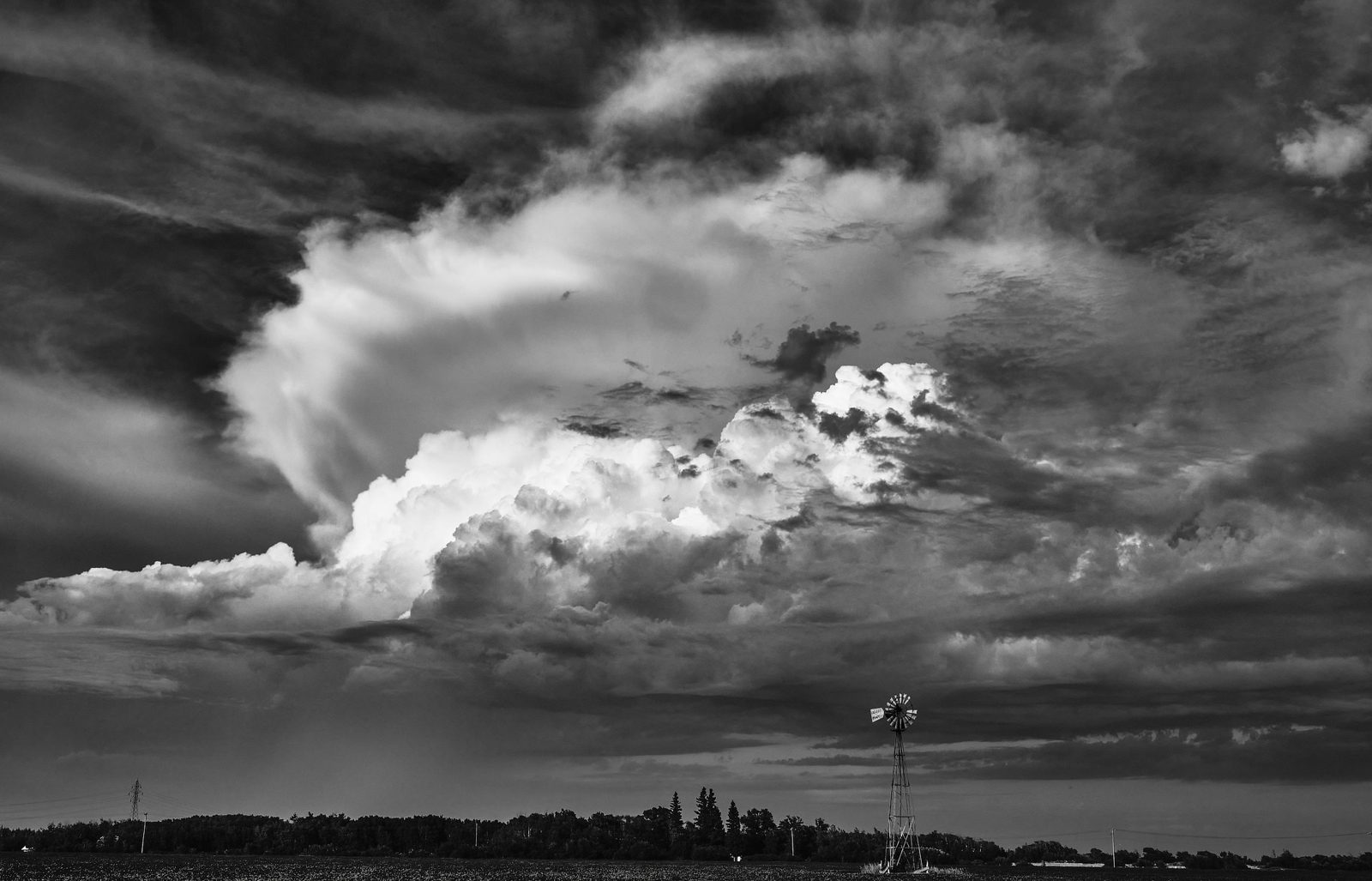 A bright storm cell rising over the prairie