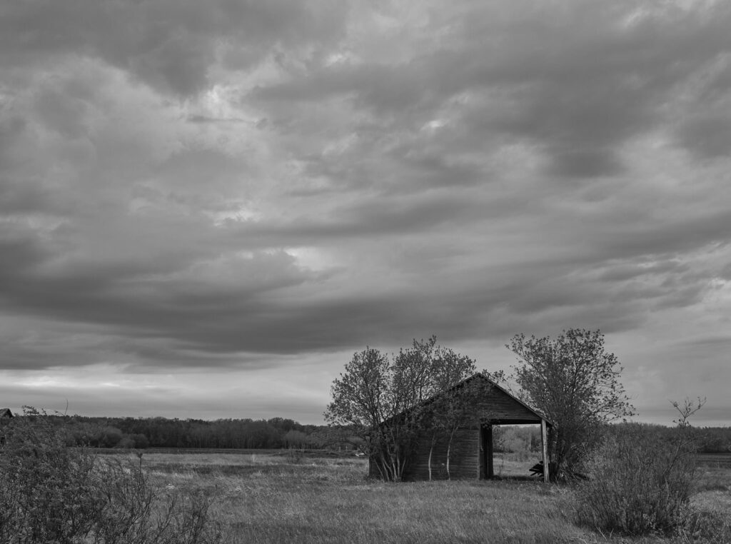Overcast sky above an old barn