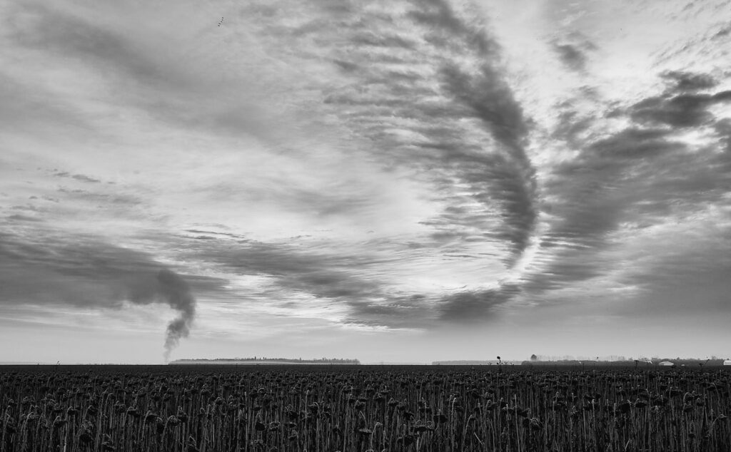 Swirling cloud streaks over a harvested field