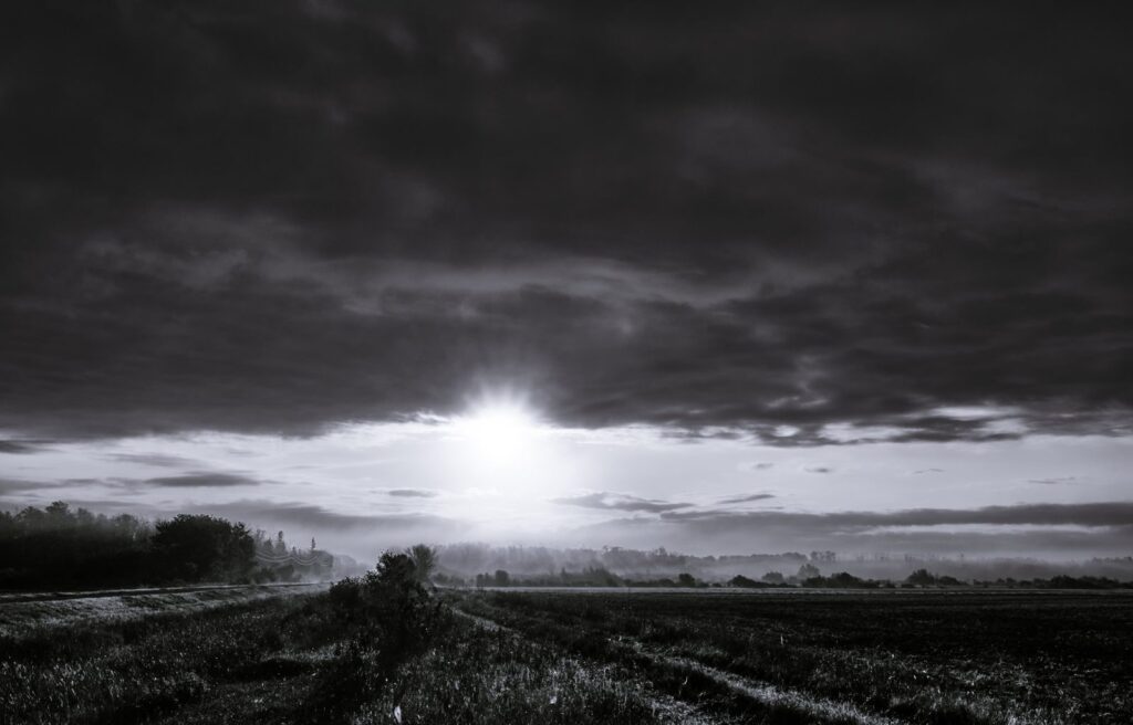 A low sun beneath a dark cloud bank