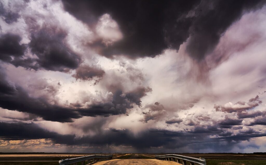 Towering dark and white storm clouds over the prairie