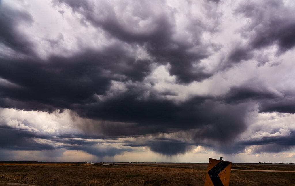 Billowing grey and white storm clouds above a flat horizon