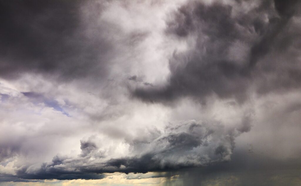 Bright white and grey thunderhead with a rain shaft below
