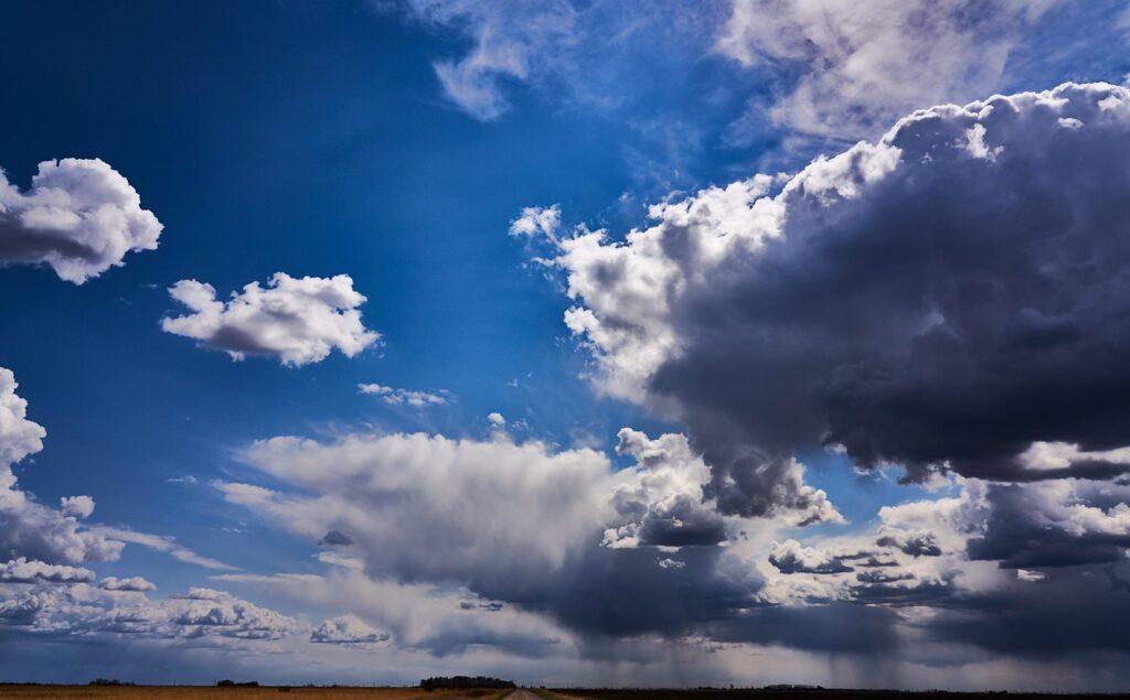 Blue sky with towering white and dark clouds