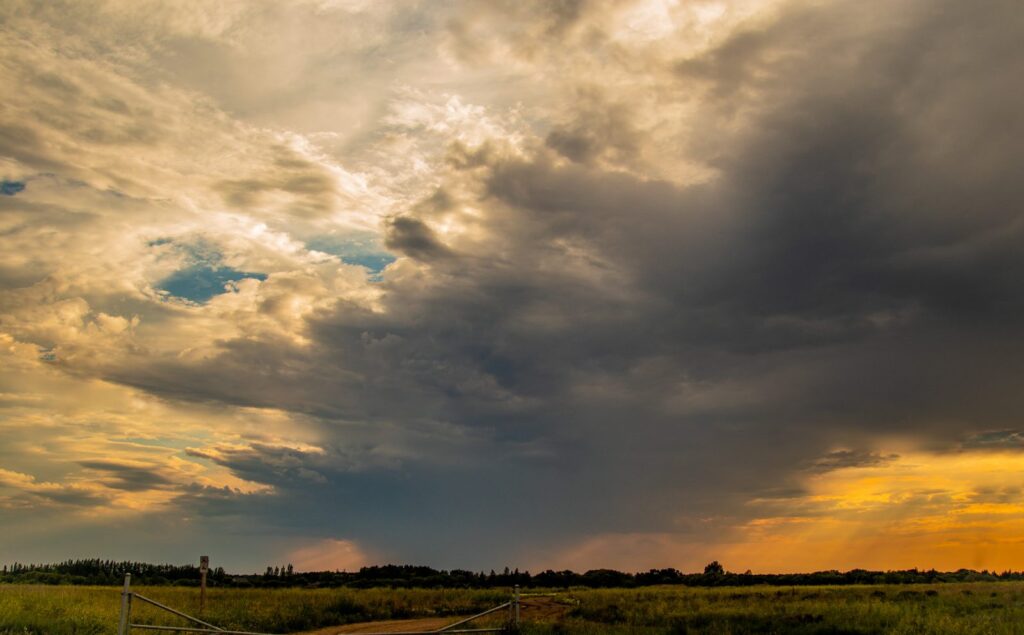 Golden and grey clouds breaking over the prairie