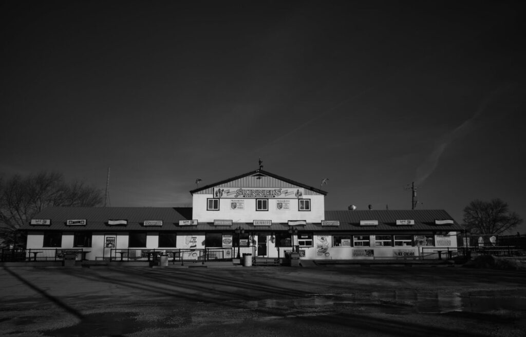 White building with a long low roof under a dark night sky
