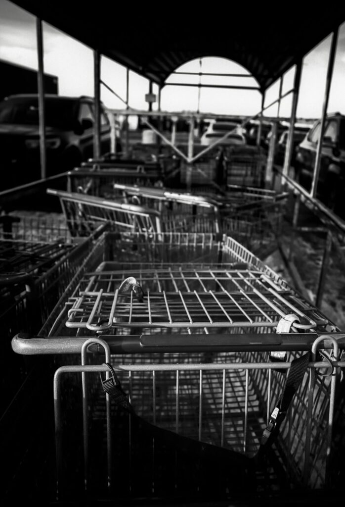 Stacked shopping carts under a covered cart corral