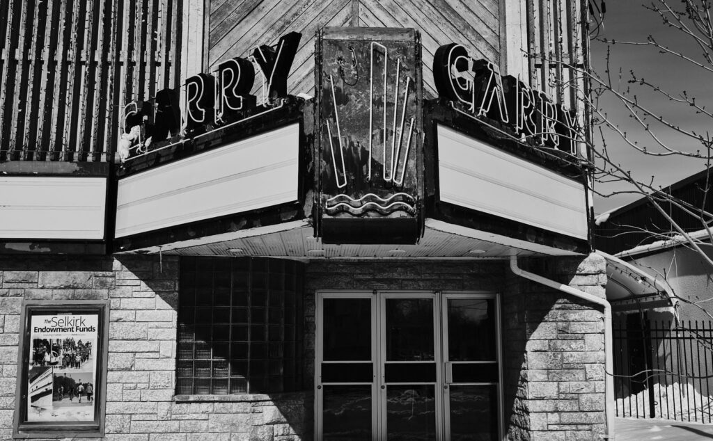 Old theatre marquee above the entrance of a stone-fronted building