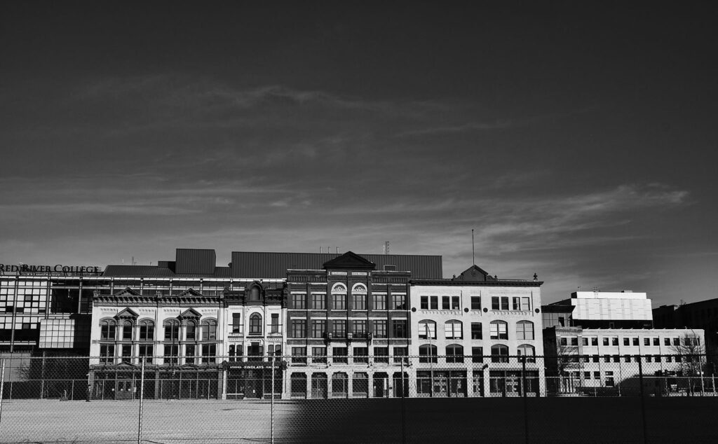 Row of historic downtown buildings against a dusk sky