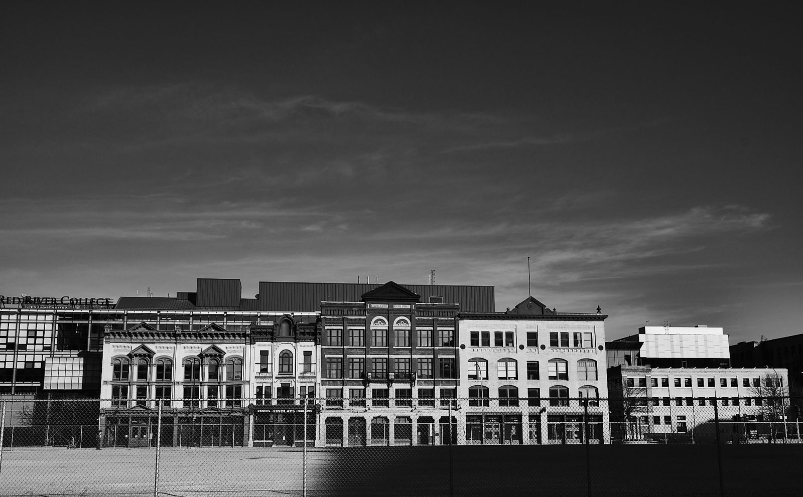 Row of historic downtown buildings against a dusk sky
