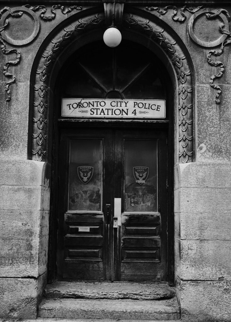 Ornate stone arched doorway of an old police station