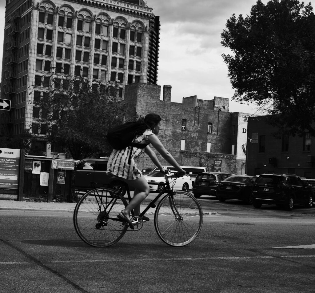 Cyclist riding through a downtown intersection
