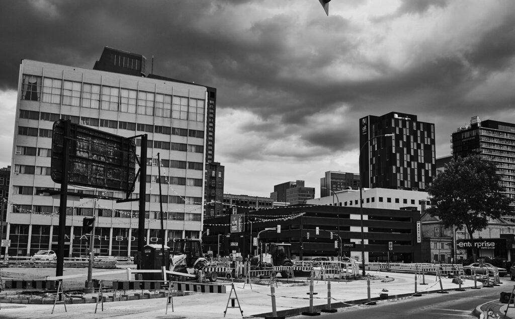 Downtown construction site with towers under a stormy sky