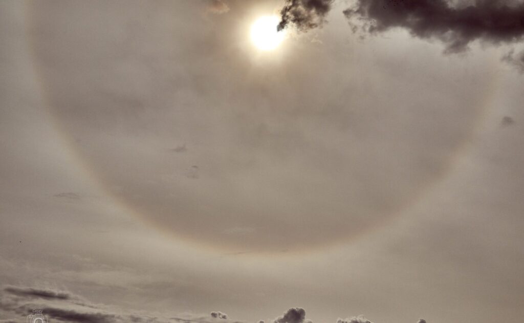 Faint halo ring around the sun through winter cloud