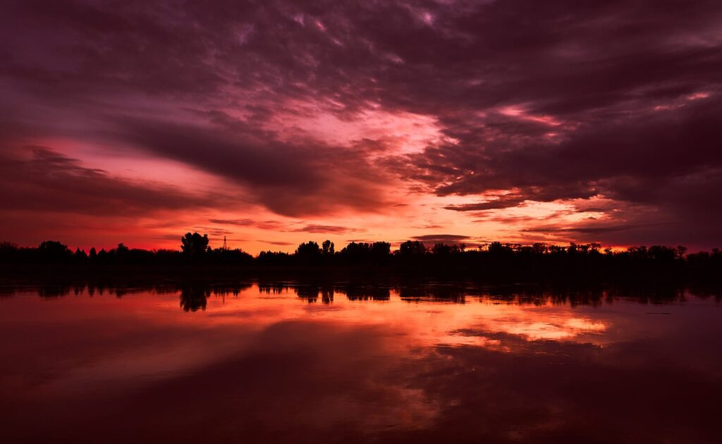 Purple and crimson sunset reflected in a calm lake