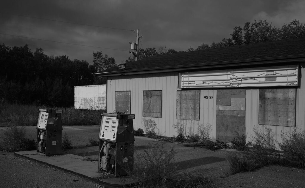 Abandoned gas station with old pumps out front