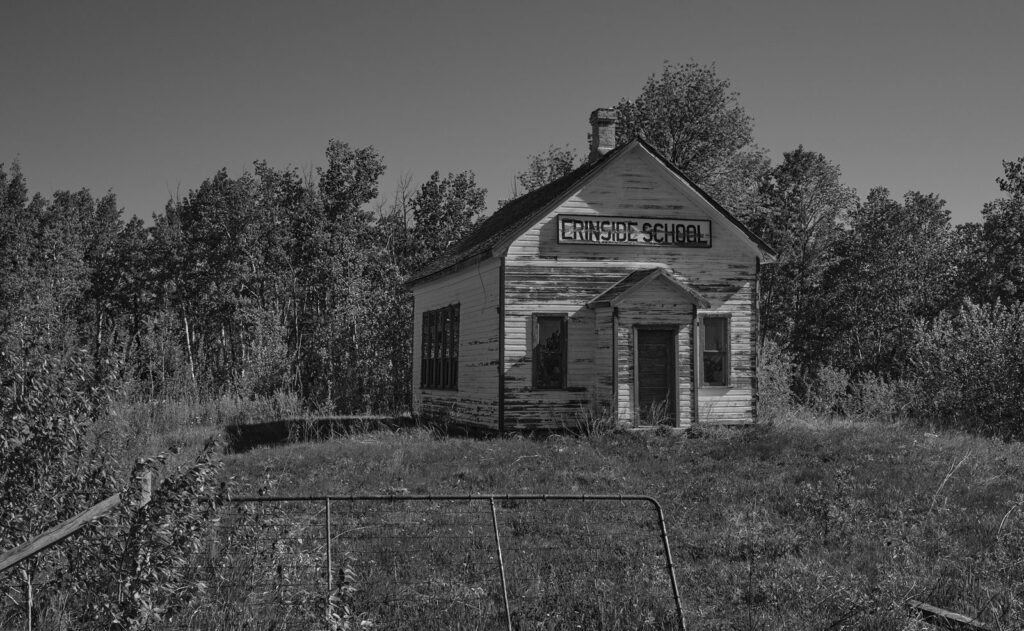 Abandoned one-room schoolhouse among the trees