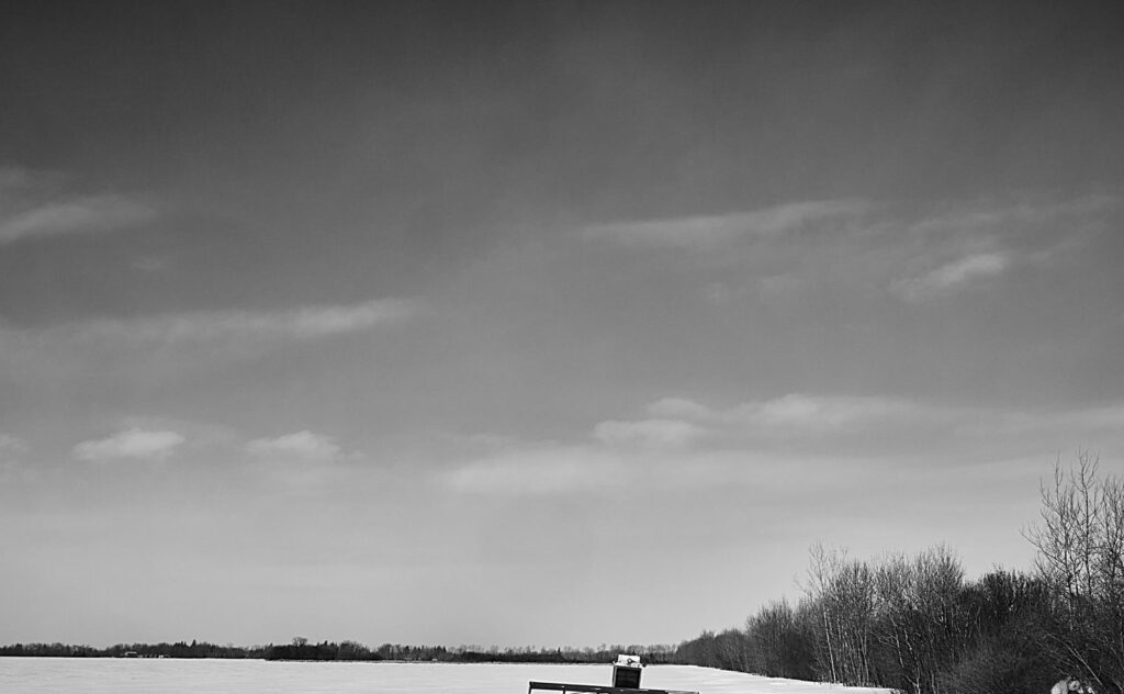 Black-and-white winter sky over a snowy field